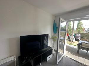 a living room with a flat screen tv on a wall at Appartement Perpignan in Perpignan +1 photo