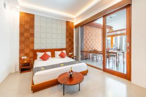 a bedroom with a bed and a table and a dining room at The Bulih Ubud in Ubud +84 photos