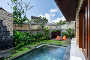 a courtyard with a swimming pool in a house at The Bulih Ubud in Ubud