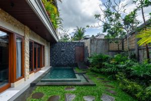 a swimming pool in the backyard of a house at The Bulih Ubud in Ubud