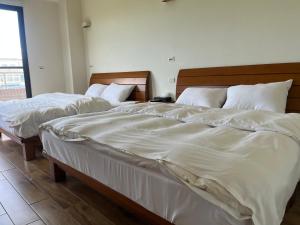 A bed or beds in a room at Furutasou B&B