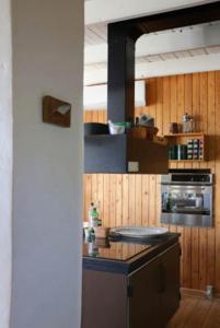 a kitchen with wooden walls and a counter top at "Lærkehuset" Right By Kalundborg Fjord in Kalundborg +27 photos