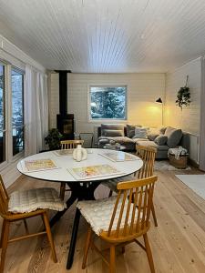 a living room with a table and chairs and a couch at Bright, Airy, And Blissful Idyllic Holiday Home in Norrtälje +16 photos