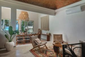 a living room with a chair and a table at New 3BR Private Beachfront Villa with Pool at Soliman in Tulum +27 photos