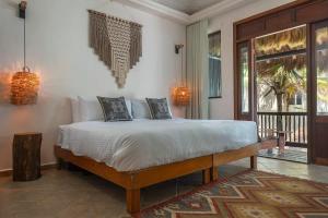 a bedroom with a bed and a balcony at New 3BR Private Beachfront Villa with Pool at Soliman in Tulum