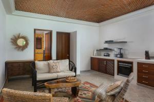 a living room with a couch and a table at New 3BR Private Beachfront Villa with Pool at Soliman in Tulum