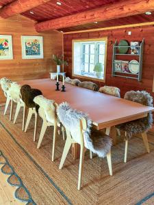 Un comedor con una gran mesa y sillas de madera. en Bjælkehus Tæt På Havet Og Charmerende Kystbyer, en Græsted