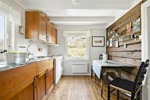 a kitchen with a sink and a table with a tableablish at Traditional House With Personal Decor in Hauge