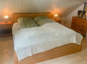 a bedroom with a wooden bed with two night stands at Traditional House With Personal Decor in Hauge