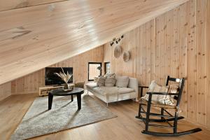 a living room with a couch and a table at Cabin Overlooking Ryfylke Fjord in Høyvik