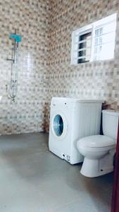 a bathroom with a toilet and a shower at Luxury low-cost flat in Akassato in Abomey-Calavi
