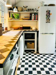 a kitchen with a black and white checkered floor at Wooden House From 1921 Near The Sea In Gilleleje in Gilleleje