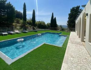 a swimming pool in a yard with green grass at Villa With Double Kitchen And Pool In Umbria in Stroncone +22 photos
