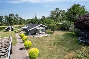 a small cabin in a garden with a yard at Beautiful Tranquil Home By Fjord Near Copenhagen in Holbæk