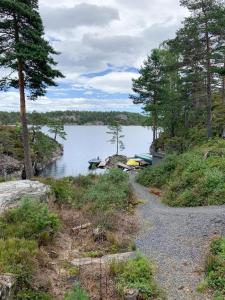 a lake with two boats on the shore at Modern & Charming Summer House Near Risør in Søndeled