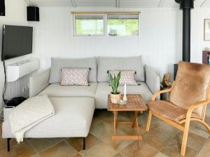 a living room with a couch and a table at House Near Sea And Forest In Lundeborg in Svendborg