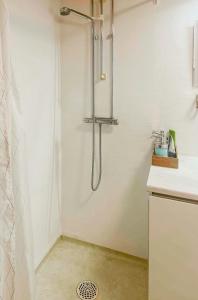 a shower with a glass door in a bathroom at Lakeside Holiday Home With Sauna Near Karlskoga in Karlskoga +20 photos