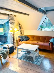 a living room with a couch and a table at Summerhouse By The North Sea in Vestervig +14 photos