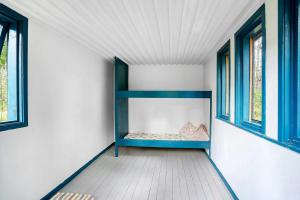 a room with a blue shelf and two windows at Architectural Holiday Home By Sejerø Bay in Nykøbing Sjælland +7 photos