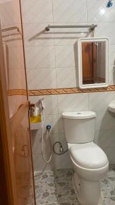 a bathroom with a white toilet and a mirror at African Angel House B&B in Stone Town +42 photos