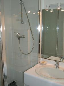 a bathroom with a shower and a sink at Le Parasol in Ars-en-Ré