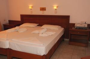 Posteľ alebo postele v izbe v ubytovaní Kyma Hotel