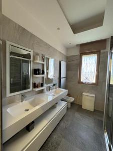 a bathroom with a large sink and a toilet at The Villa Pool & Relax in Bari +7 photos