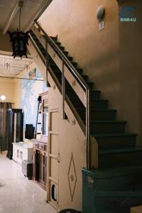 a staircase in a building with a green stair railing at City-Center Heritage Stay Up to 12 pax in George Town