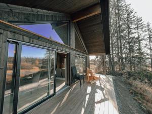a house with sliding glass doors on a deck at Modern Mountain Cabin Near Syningtoppen in Torpo