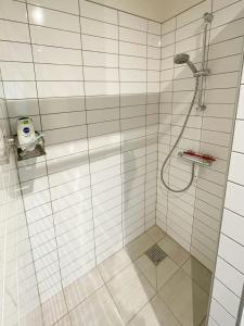 a bathroom with a shower with a glass door at Stunning Sunrises Over Harre Vig in Roslev +32 photos