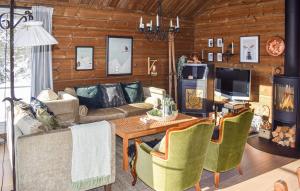 a living room with a couch and a table at Cozy, Traditional Cabin At Kyrkjebygdheia in Fjone
