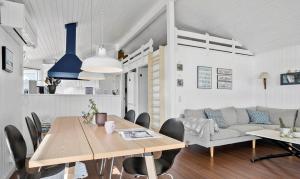 a living room with a table and a couch at Cottage By Kolding Fjord With Panoramic View in Kolding