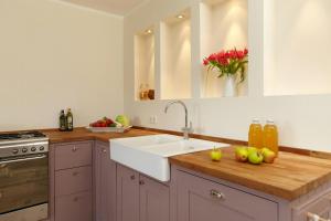 a kitchen with a sink and a counter with apples on it at Light Flooded Apartment With Sauna in Walow