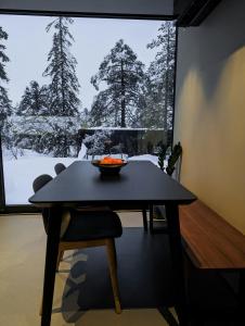 a dining room table with a bowl of fruit on it at Modern Cabin By Snøhetta At Blefjell in Svene