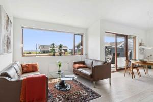a living room with a couch and a table at Beautiful Home In As Vig, 100 M From The Beach in Sønderby
