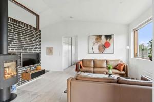 a living room with a couch and a fireplace at Beautiful Home In As Vig, 100 M From The Beach in Sønderby