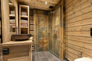 a bathroom with a sink and a glass shower at Cabin With Panoramic View Over Hardangervidda in Dagali +23 photos