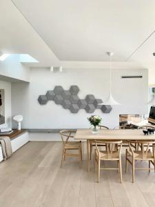 a dining room with a table and chairs at Stylish 70'S Villa With Forest And Lake View In Ry in Ry