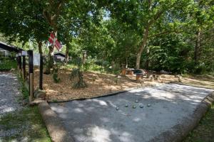 a road with balls on the ground under trees at Idyllic Gem On Als Odde With Activities in Hadsund