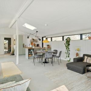 a living room and kitchen with a table and chairs at Relaxed Lifestyle And Luxury In Melby in Melby