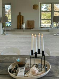 a group of candles on a plate on a table at Beach House In Liseleje in Liseleje +29 photos