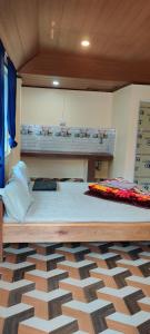 a large bed in a room with a wooden ceiling at Tranquil Hill Top Homestay in Kalimpong
