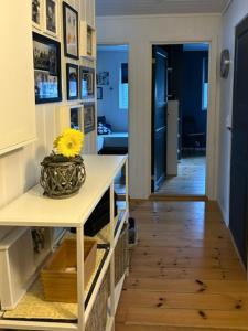 a room with a vase with a yellow flower on a table at Charming Cabin With Archipelago Views In Sogn in Ånneland +11 photos