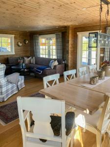 a living room with a wooden table and chairs at Family Cabin At Blefjell in Lampeland