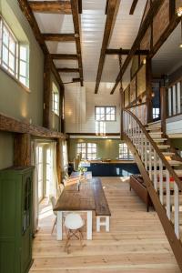 a large room with a wooden table and stairs at Spacious Vacation Apartment With A Garden View in Walow
