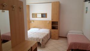 Postel nebo postele na pokoji v ubytování Hotel Canova