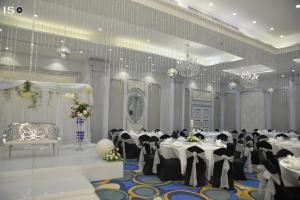 a banquet hall with white tables and black chairs at Tolip El Narges in Cairo +37 photos