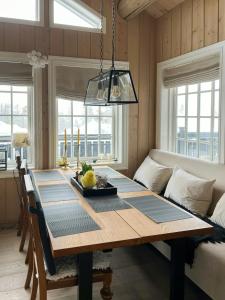 a dining room table with a bowl of fruit on it at Mountain Cabin With Sauna, Jacuzzi And Views in Nord Torpa