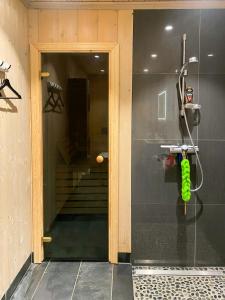 a shower in a bathroom with a glass door at Mountain Cabin With Sauna, Jacuzzi And Views in Nord Torpa