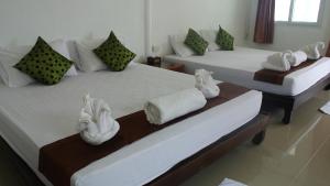 two beds in a room with towels on them at Bottle Beach 2 Bungalows in Bottle Beach +37 photos